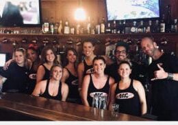 A group of people sitting at the bar